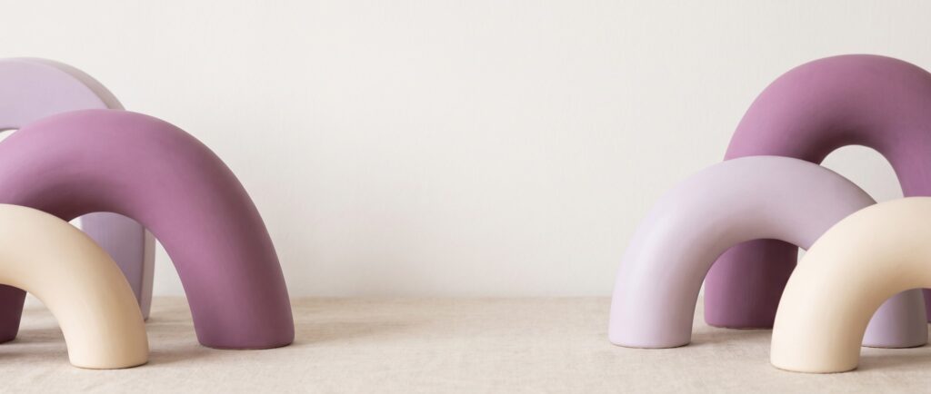 Abstract banner of orchid and cream sculptural ceramic arches