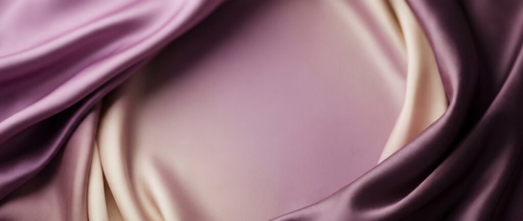 Abstract banner of soft orchid, plum and cream satin folds